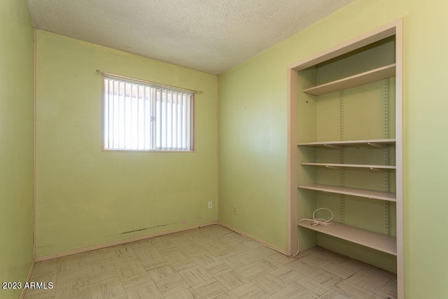 unfurnished bedroom featuring a textured ceiling