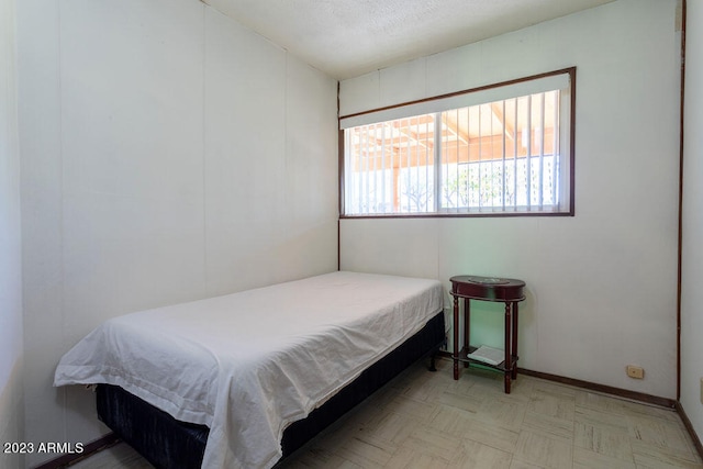 bedroom featuring light parquet flooring