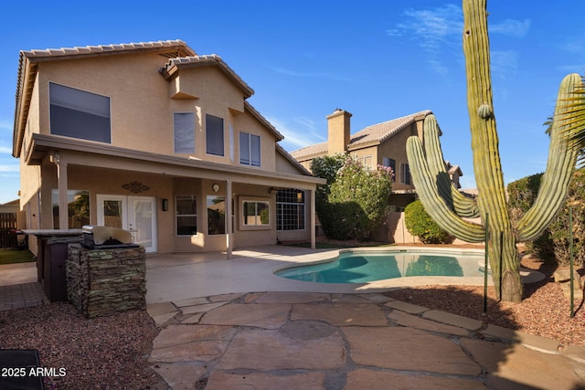 4753 E Bighorn Ave, Phoenix, AZ 85044 - rear view of property featuring a patio, stucco siding, area for grilling, and a fenced backyard