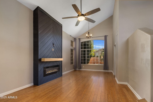 4753 E Bighorn Ave, Phoenix, AZ 85044 - unfurnished living room with a ceiling fan, wood finished floors, a large fireplace, a chandelier, and baseboards