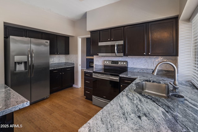 4753 E Bighorn Ave, Phoenix, AZ 85044 - kitchen with stainless steel appliances, a sink, light stone countertops, and tasteful backsplash