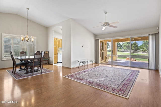 8431 W Utopia Rd, Peoria, AZ 85382 - dining space with vaulted ceiling, wood finished floors, a ceiling fan, a chandelier, and arched walkways