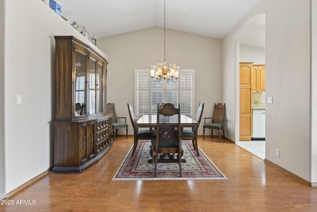 8431 W Utopia Rd, Peoria, AZ 85382 - dining space featuring healthy amount of natural light, a chandelier, lofted ceiling, light wood finished floors, and arched walkways