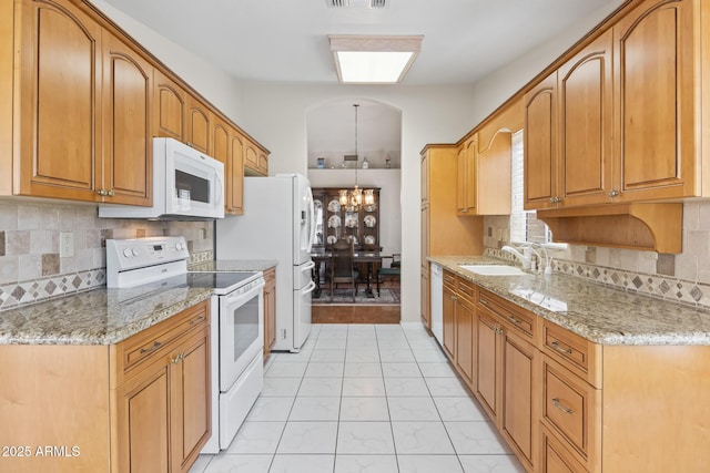 8431 W Utopia Rd, Peoria, AZ 85382 - kitchen featuring white appliances, light stone counters, and tasteful backsplash