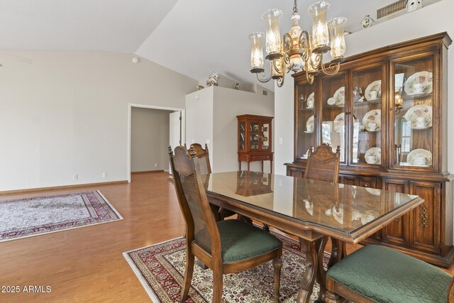 8431 W Utopia Rd, Peoria, AZ 85382 - dining area with a chandelier, lofted ceiling, and light wood-type flooring