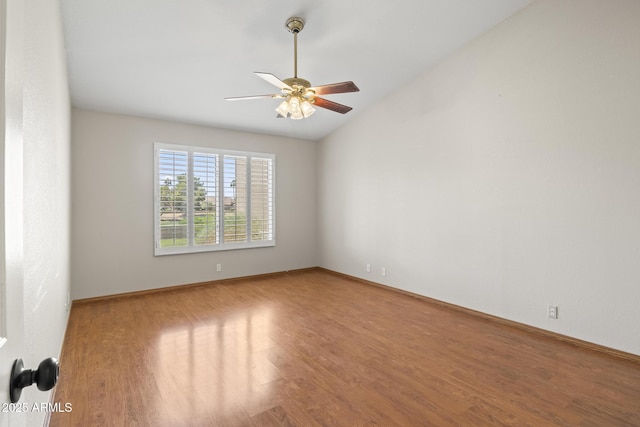 8431 W Utopia Rd, Peoria, AZ 85382 - empty room featuring wood finished floors, a ceiling fan, and vaulted ceiling