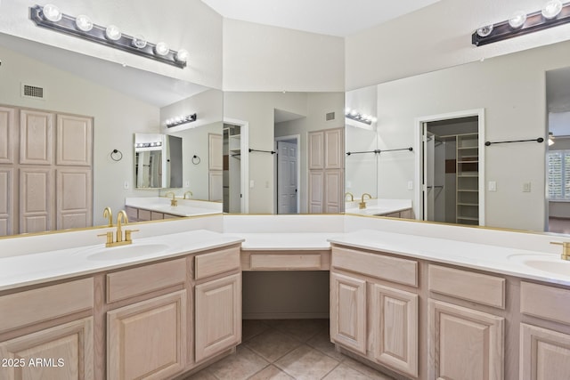 8431 W Utopia Rd, Peoria, AZ 85382 - bathroom with vaulted ceiling, double vanity, tile patterned flooring, and a walk in closet