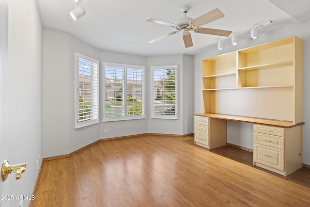 8431 W Utopia Rd, Peoria, AZ 85382 - unfurnished office with rail lighting, plenty of natural light, light wood-style flooring, and built in study area