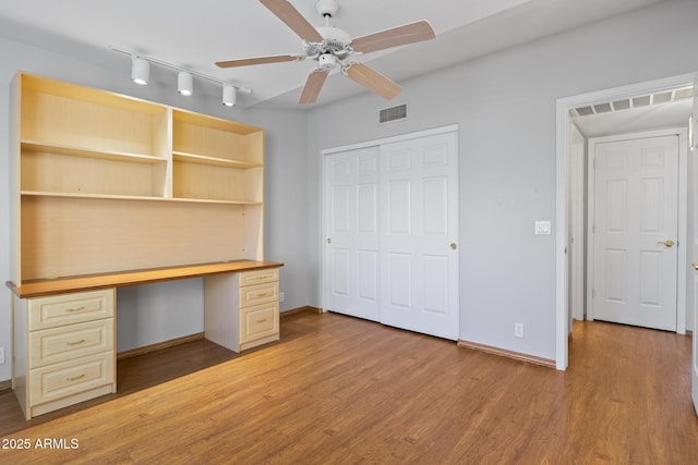 8431 W Utopia Rd, Peoria, AZ 85382 - unfurnished office featuring built in study area, a ceiling fan, light wood-type flooring, and rail lighting
