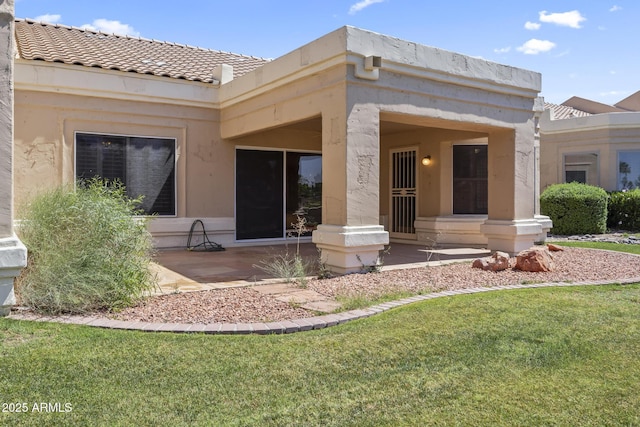 8431 W Utopia Rd, Peoria, AZ 85382 - rear view of property featuring a lawn, a tile roof, and stucco siding