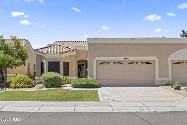 8431 W Utopia Rd, Peoria, AZ 85382 - view of front of home with stucco siding, driveway, a tiled roof, and a garage