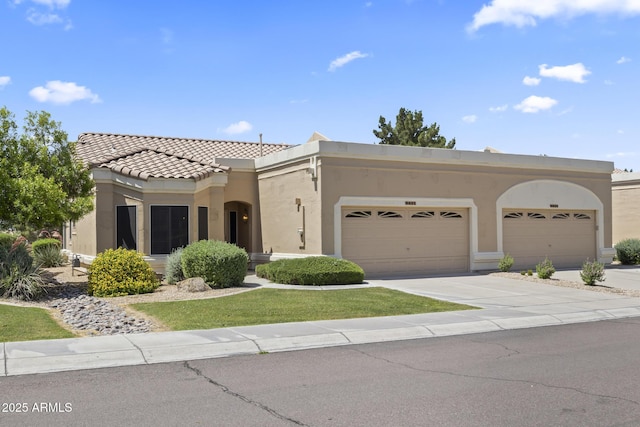 8431 W Utopia Rd, Peoria, AZ 85382 - view of front of home with stucco siding, a garage, driveway, and a tile roof
