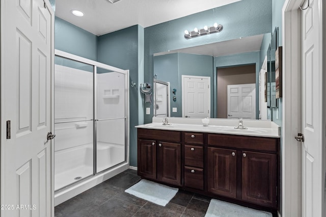 bathroom with vanity and a shower with shower door