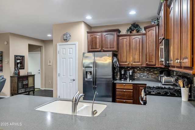 kitchen featuring appliances with stainless steel finishes, sink, and backsplash