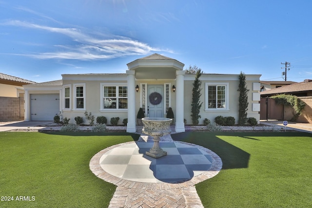 view of front of home with a front lawn and a garage