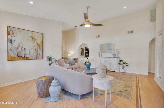 living room with light hardwood / wood-style floors and ceiling fan