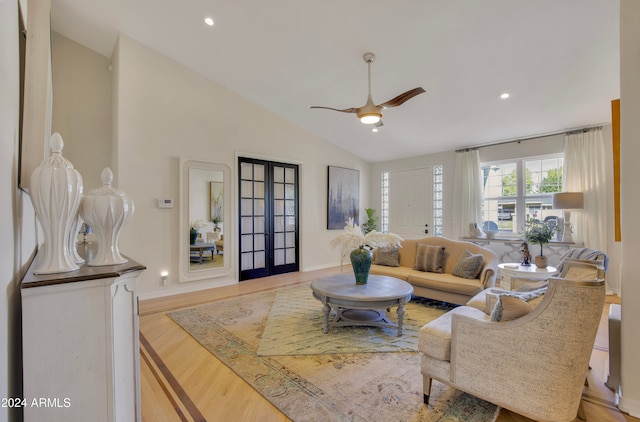 living room with lofted ceiling, french doors, light wood-type flooring, and ceiling fan