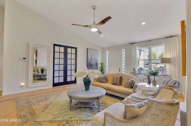 living room with french doors, light hardwood / wood-style flooring, lofted ceiling, and ceiling fan