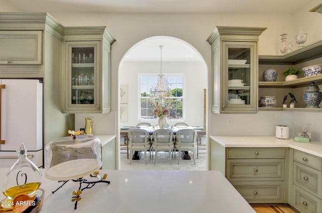 kitchen featuring a chandelier, decorative light fixtures, and white refrigerator