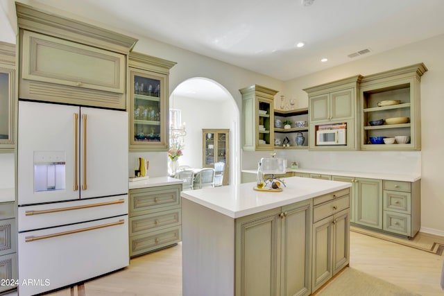 kitchen with a kitchen island, light wood-type flooring, and white appliances