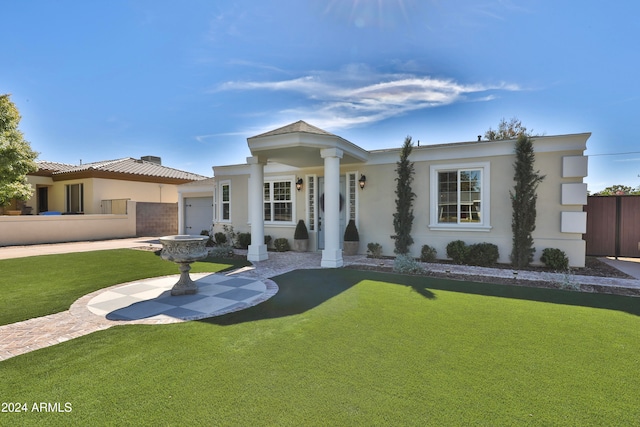 view of front of home with a garage and a front lawn