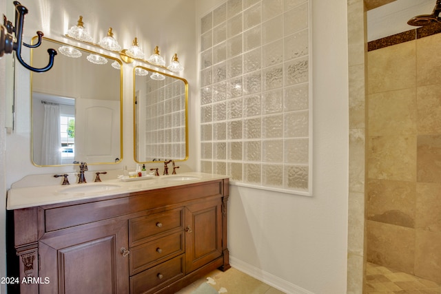 bathroom with vanity, a tile shower, and tile patterned floors