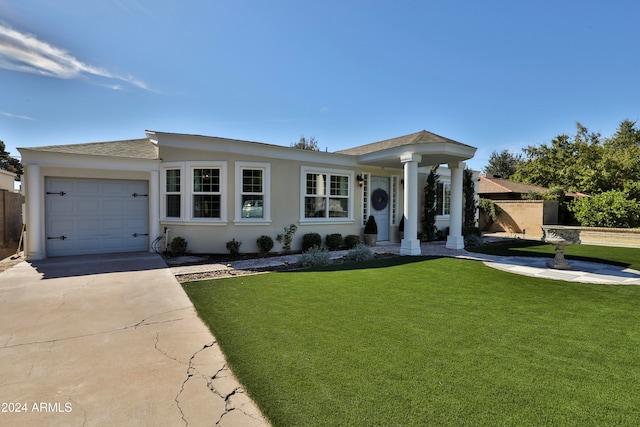 view of front of home with a front lawn and a garage