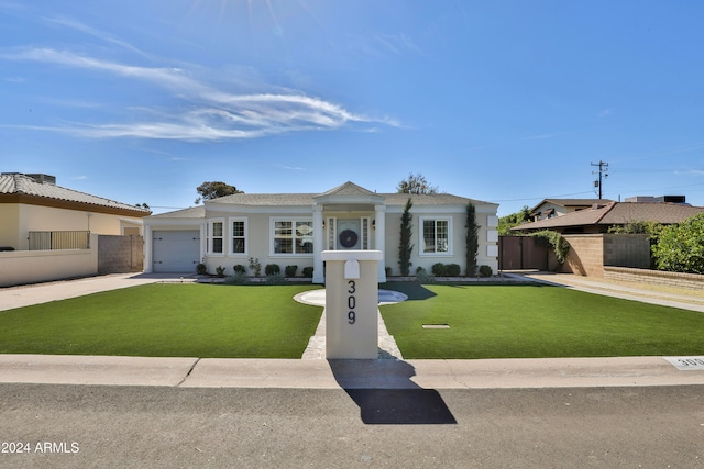 single story home featuring a garage and a front lawn