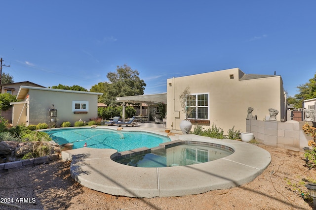 view of pool with a patio and an in ground hot tub