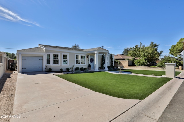 view of front of property featuring a front lawn and a garage