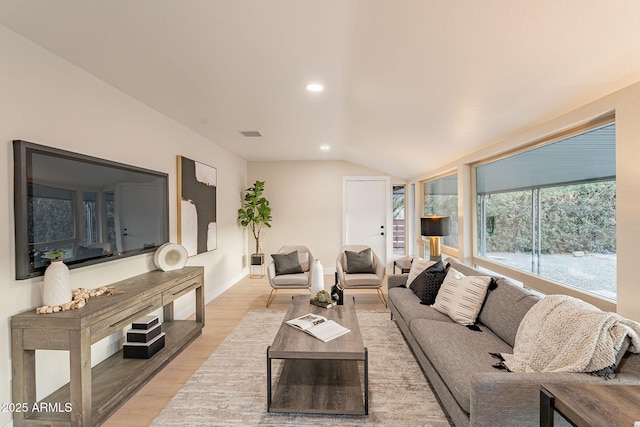 living area featuring recessed lighting, visible vents, lofted ceiling, and light wood finished floors