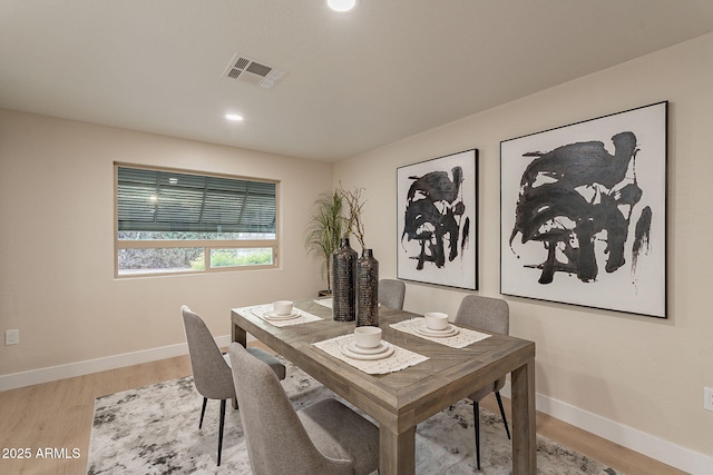 dining room with baseboards, recessed lighting, visible vents, and light wood-style floors