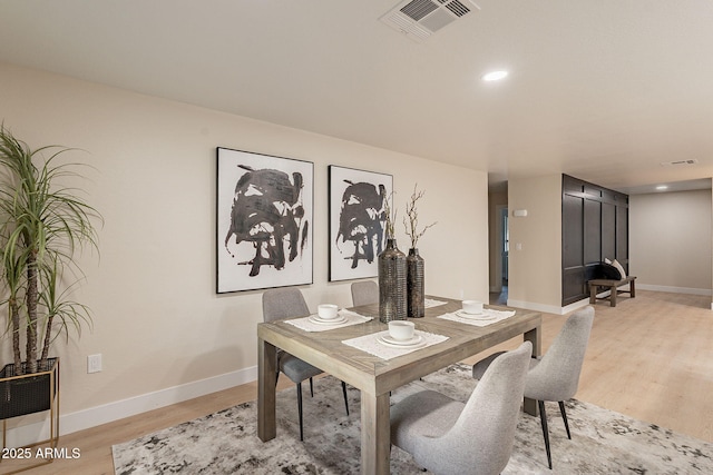 office space with light wood finished floors, recessed lighting, visible vents, and baseboards