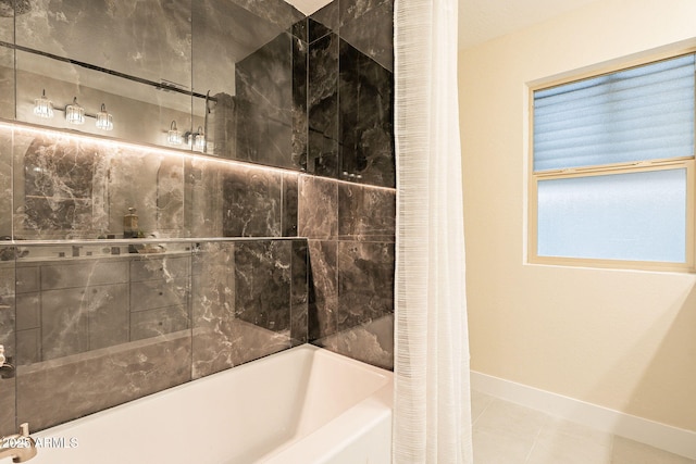 full bathroom with tile patterned flooring, shower / bath combo with shower curtain, and baseboards