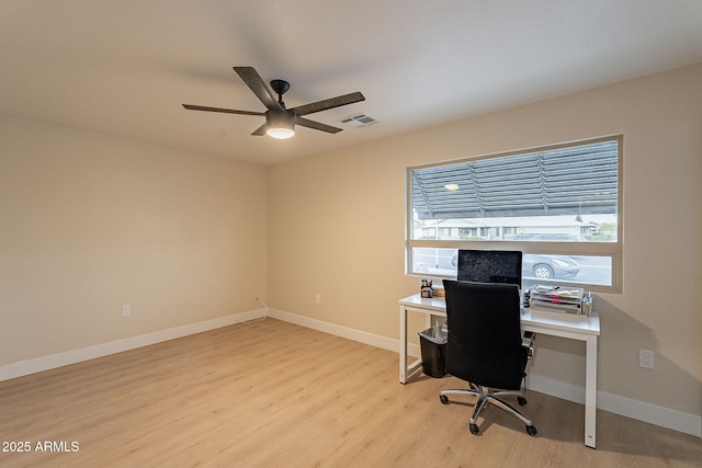 office featuring visible vents, ceiling fan, baseboards, and wood finished floors