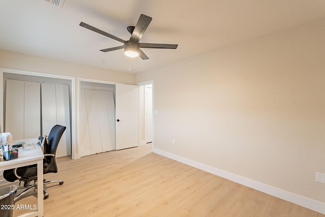 office space with ceiling fan, light wood-style flooring, and baseboards