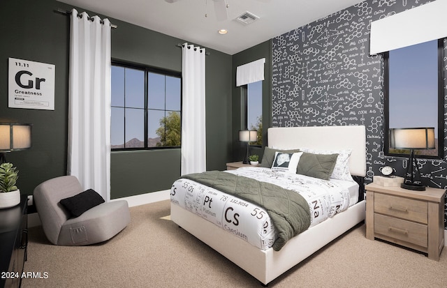 bedroom with light carpet and ceiling fan