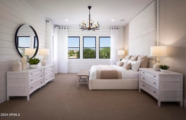 carpeted bedroom featuring an inviting chandelier