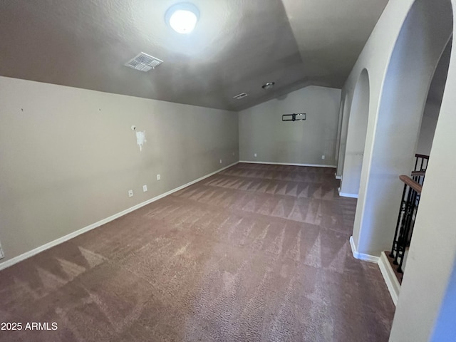 514 E Pearce Rd, Phoenix, AZ 85042 - additional living space featuring vaulted ceiling, arched walkways, carpet flooring, and baseboards