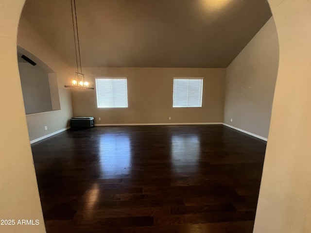 514 E Pearce Rd, Phoenix, AZ 85042 - unfurnished dining area with dark wood-type flooring, lofted ceiling, and baseboards