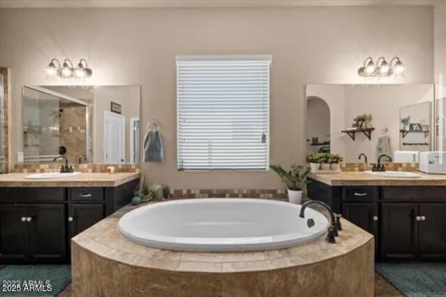 514 E Pearce Rd, Phoenix, AZ 85042 - bathroom with a stall shower, a bath, two vanities, and a chandelier
