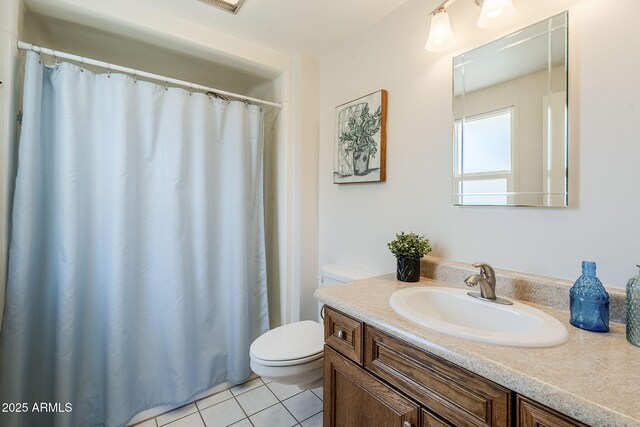 full bath featuring toilet, vanity, a shower with shower curtain, and tile patterned floors