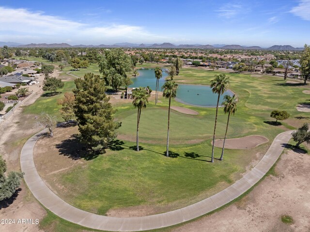 bird's eye view with view of golf course and a water and mountain view