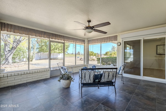 sunroom with ceiling fan