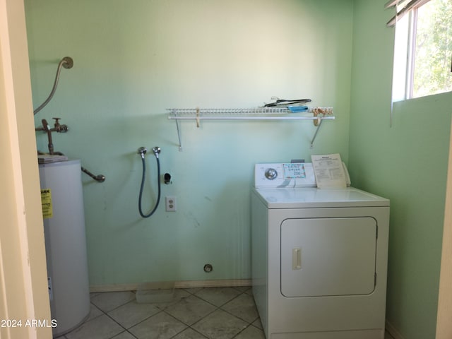 washroom with washer / clothes dryer, water heater, and light tile patterned flooring