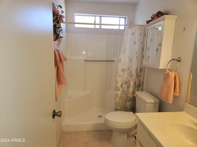 bathroom with tile patterned floors, vanity, curtained shower, and toilet