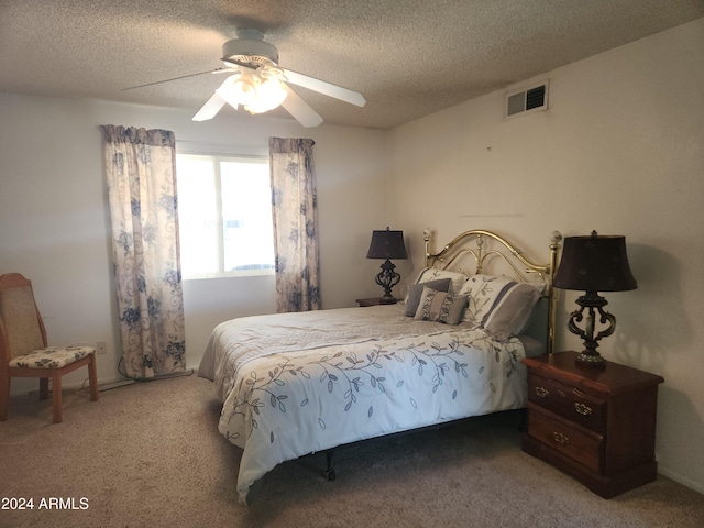 bedroom with carpet flooring, ceiling fan, and a textured ceiling