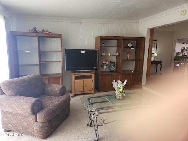 carpeted living room with crown molding