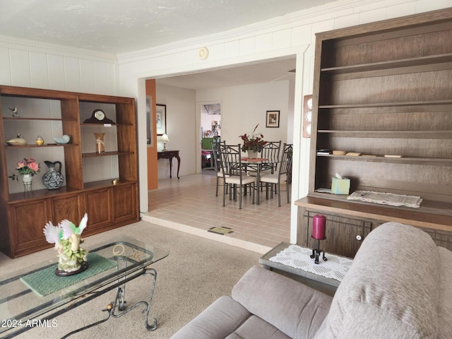 tiled living room featuring crown molding