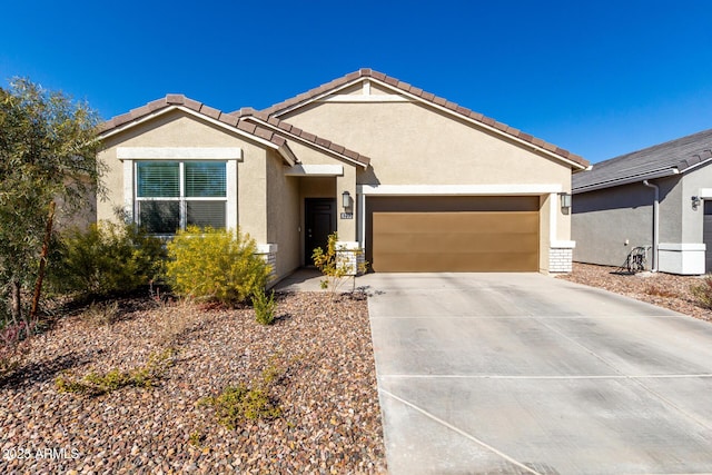 8222 W Clemente Way, Florence, AZ 85132 - ranch-style house featuring an attached garage, stucco siding, driveway, and a tile roof